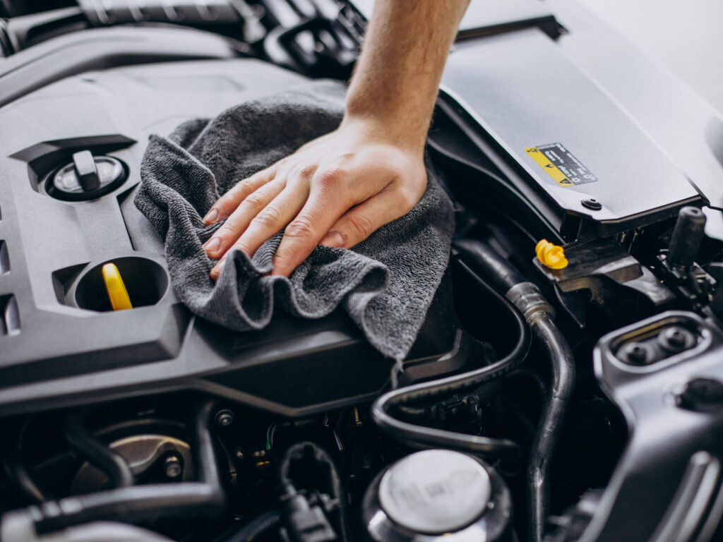 Man polishing car inside at car service